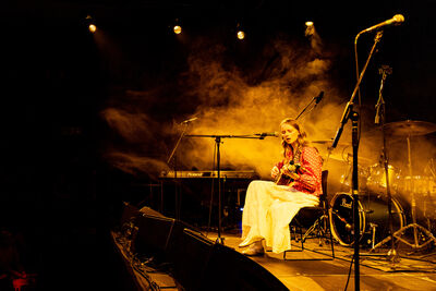 Girl on stage playing the guitar